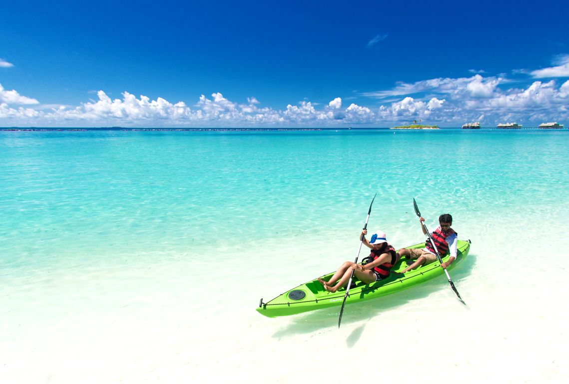 Kayaking in Abel Tasman National Park with golden sand beach and native bush